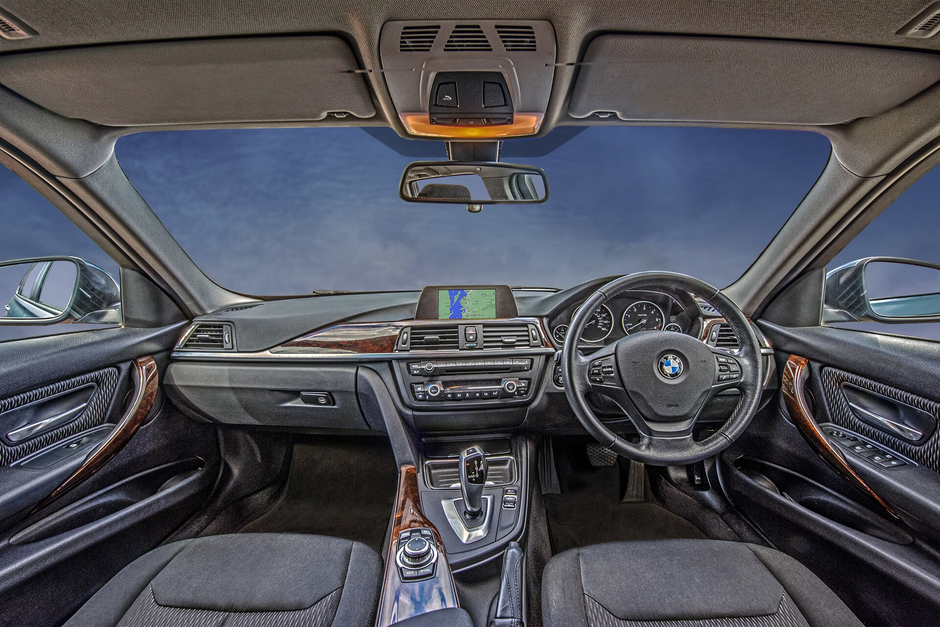 Interior of a car showing the dashboard, screen and steering wheel