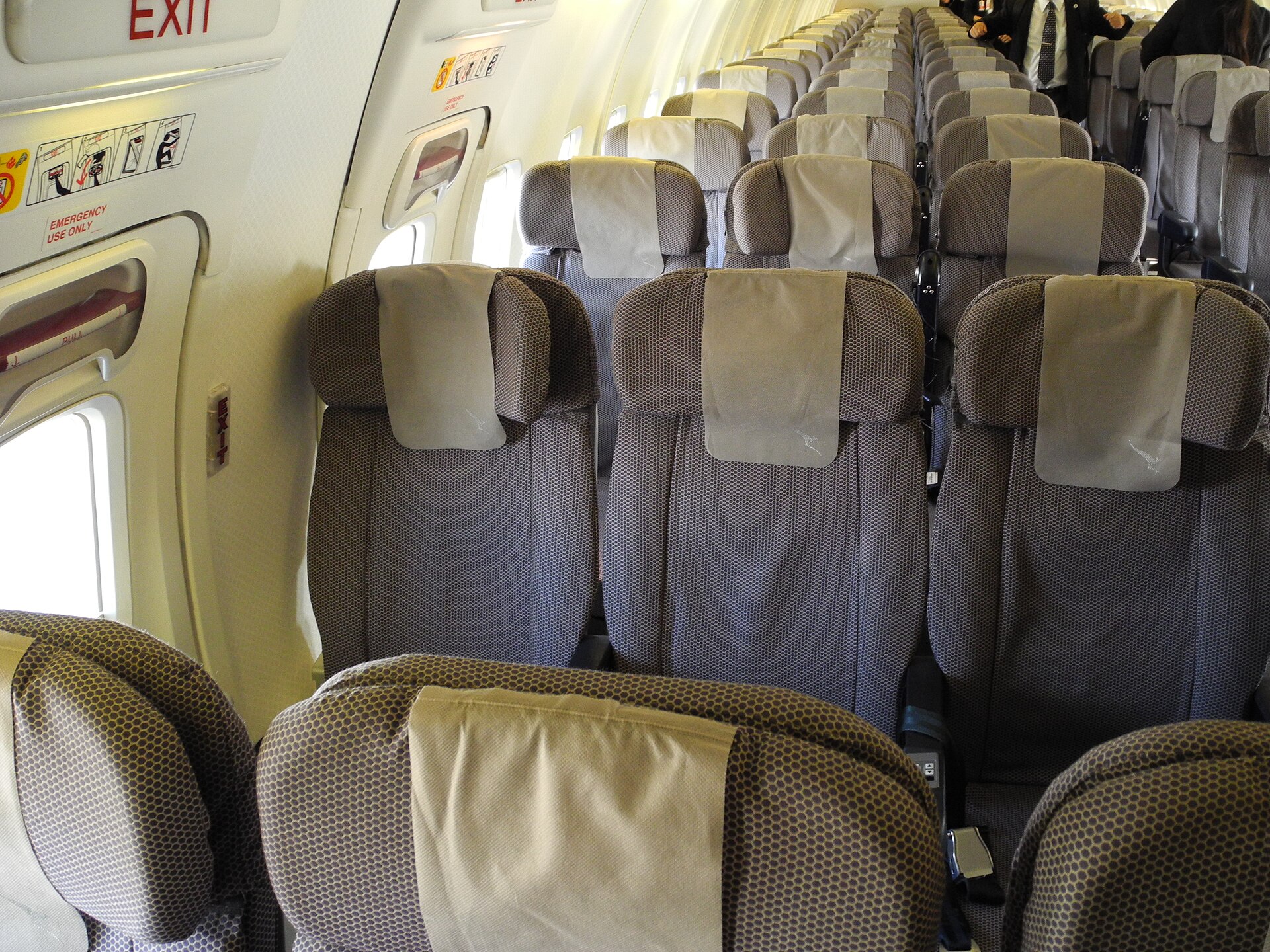 Rows of economy seats inside an airplane cabin